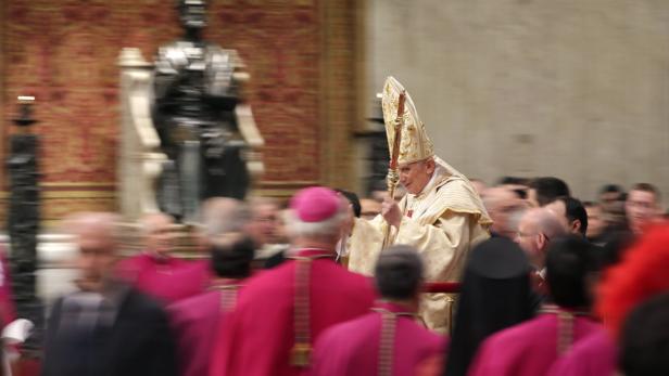 Papst Benedikt XVI. während einer Prozession in einer Kirche.