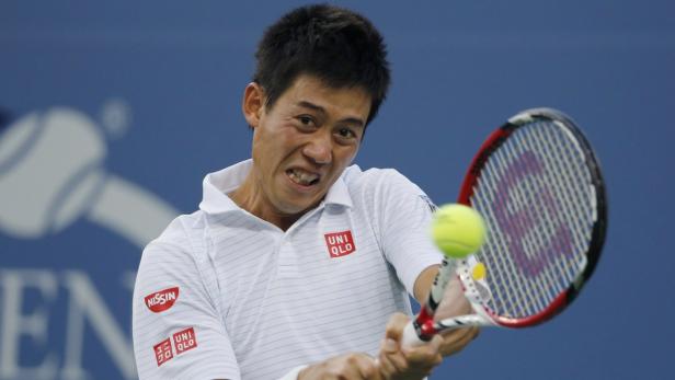 Nishikori of Japan hits a return to Wawrinka of Sw