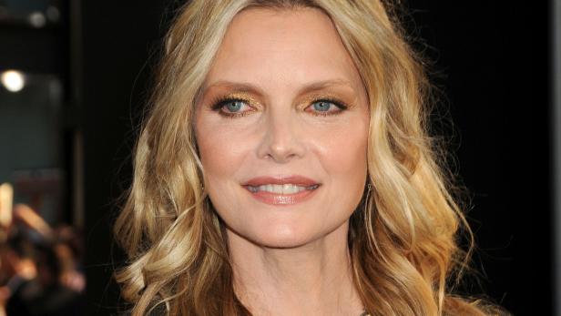 Porträt von Michelle Pfeiffer mit blonden, gewellten Haaren und goldenem Lidschatten.