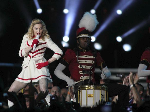 Madonna tritt mit einem Schlagzeuger bei einer Veranstaltung auf.