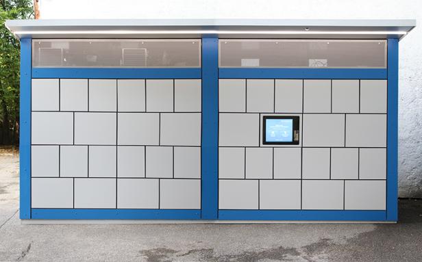 Ein blauer Paketautomat mit einem Touchscreen zur Bedienung.
