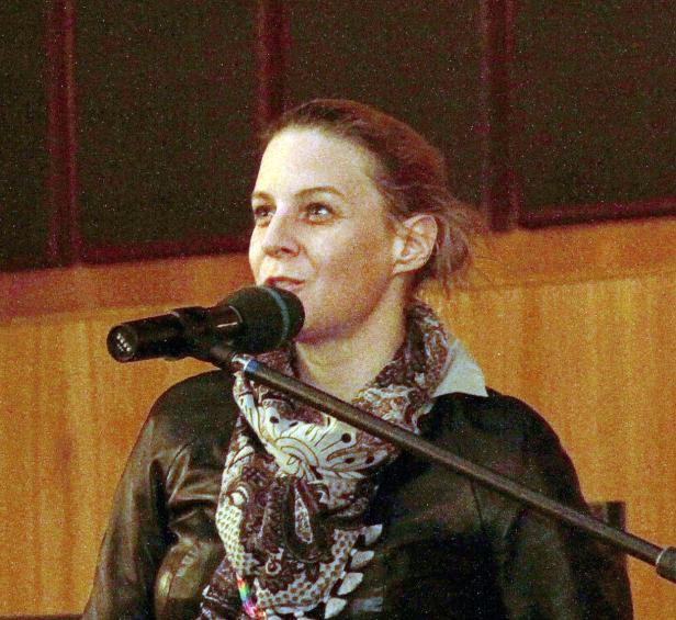 Eine Frau spricht in ein Mikrofon.