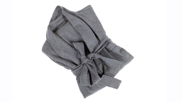 Ein grauer Bademantel liegt auf einem weißen Hintergrund.