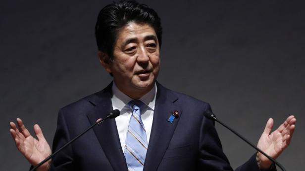 Japan's PM Abe gestures as he gives a speech durin