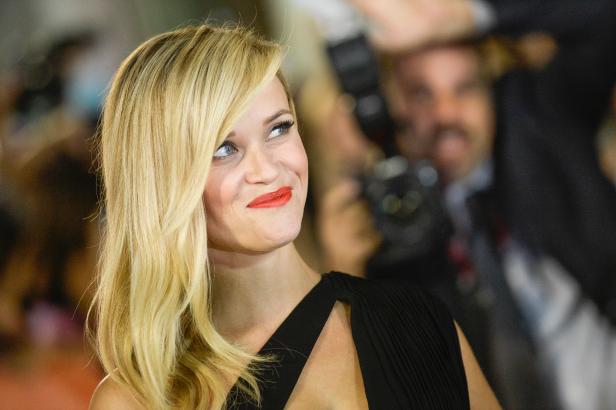 Reese Witherspoon lächelt auf einer Veranstaltung in die Ferne.