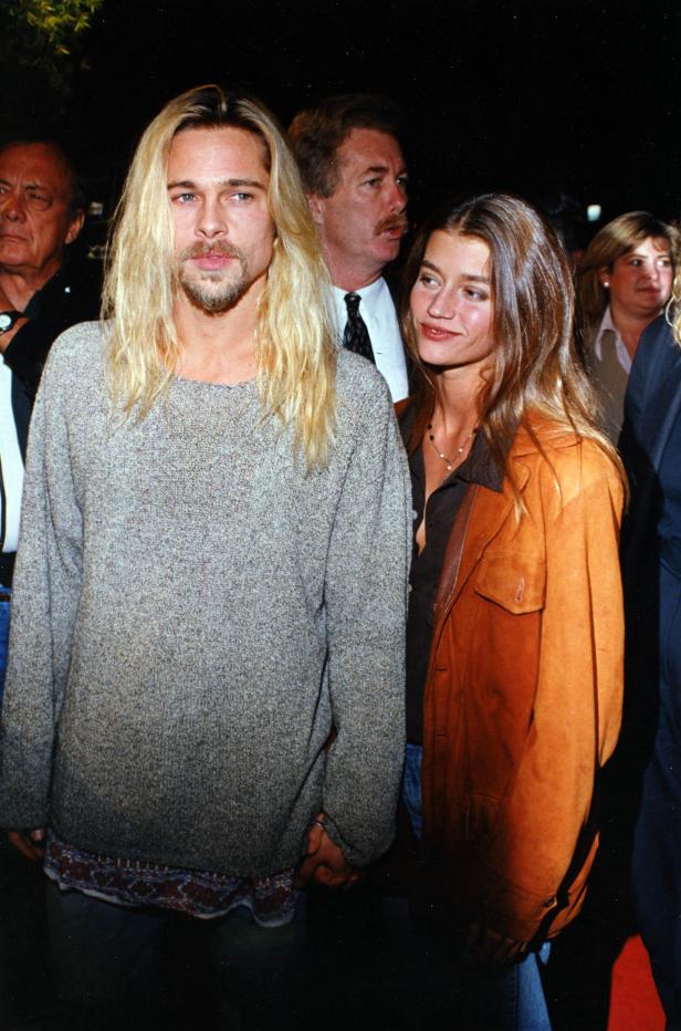 Brad Pitt mit langem blonden Haar und seine Begleiterin posieren zusammen.