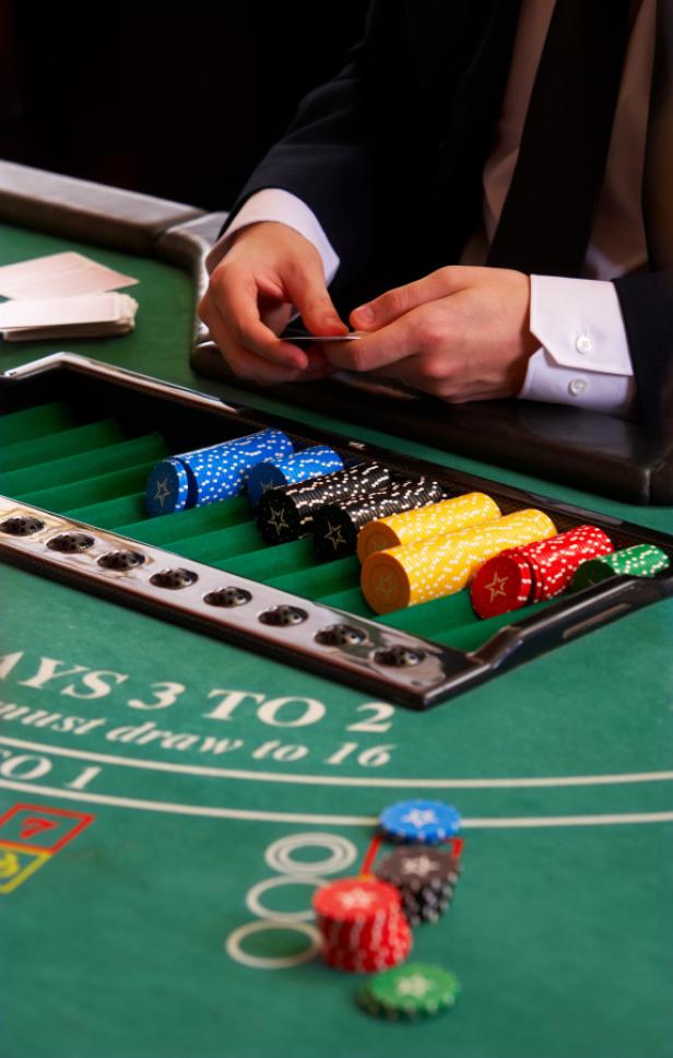 Ein Croupier teilt Karten an einem Blackjack-Tisch aus.