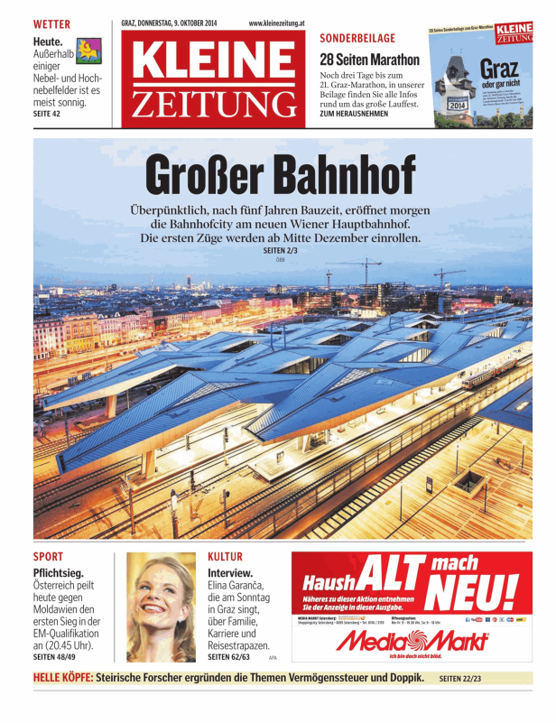 Luftaufnahme des Wiener Hauptbahnhofs mit Bahnsteigen und Zügen.