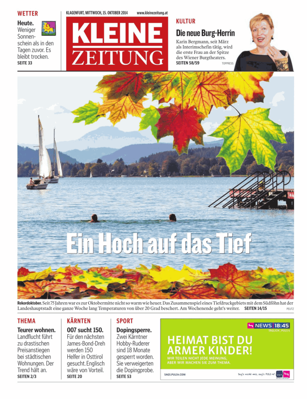 Segelboote auf dem Wörthersee im Herbst mit bunten Blättern im Vordergrund.