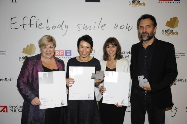 Vier Personen posieren mit silbernen Effie Awards Urkunden.