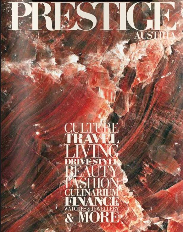 Das Cover des „Prestige Austria“-Magazins zeigt ein abstraktes Muster in Rot- und Weißtönen.