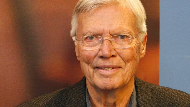 Porträt eines älteren Mannes mit Brille und grauem Haar.