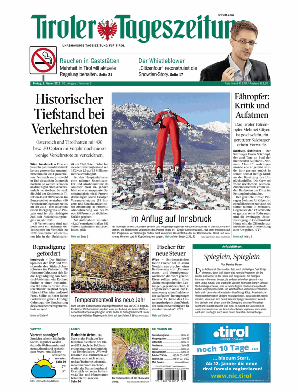Ein Skispringer im Anflug auf Innsbruck vor schneebedeckten Bergen.