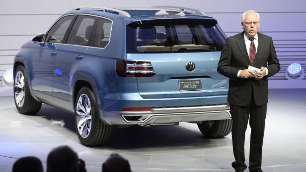 Ein Mann präsentiert den blauen Volkswagen CrossBlue auf einer Bühne.