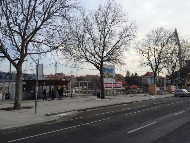Eine Baustelle in der Stadt mit einem Wartehäuschen im Vordergrund.