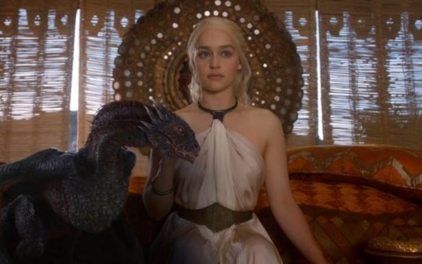 Daenerys Targaryen sitzt mit einem ihrer Drachen auf einem verzierten Thron.