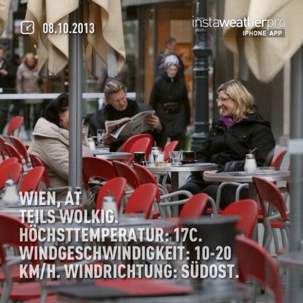 Menschen sitzen in einem Wiener Café im Freien.