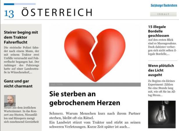 Ein rotes, zerbrochenes Herzsymbol auf einer Zeitungsseite.