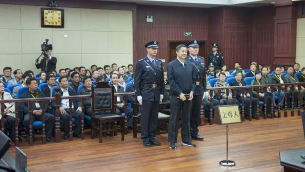 Bo Xilai stands as the decision of his second tria