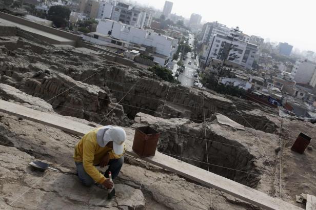 Ein Mann arbeitet an einer archäologischen Ausgrabungsstätte in einer Stadt.