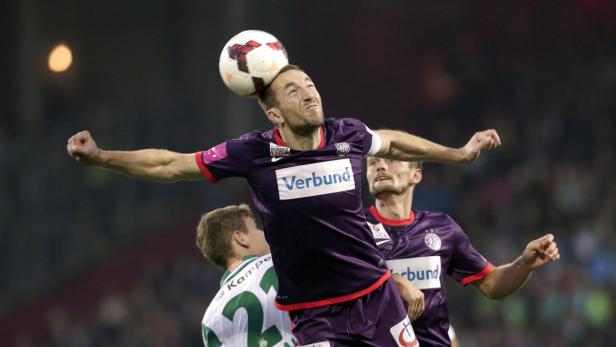 Ein Fußballspieler köpft den Ball während eines Spiels.