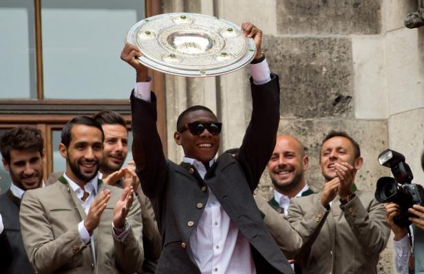 David Alaba vom FC Bayern München feiert mit der Meisterschale.