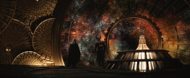 Zwei Figuren stehen in einem Raum mit einem großen Fenster, das einen Blick auf den Weltraum bietet.