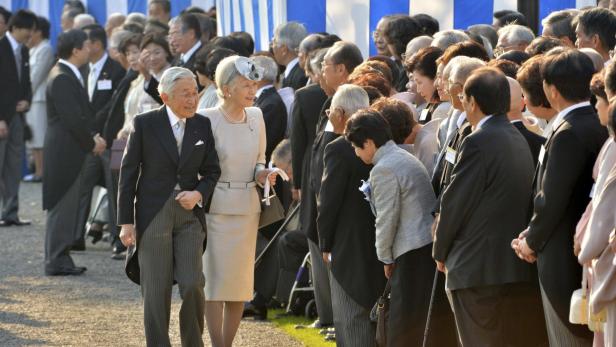 Der ehemalige japanische Kaiser Akihito und Kaiserin Michiko inmitten einer Menschenmenge.