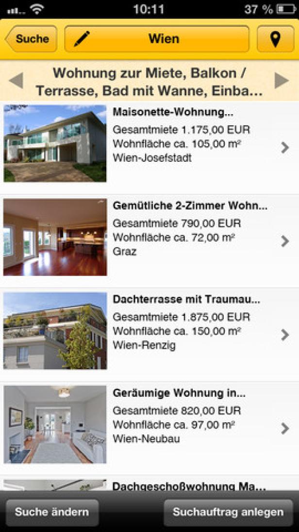 Ein Smartphone-Bildschirm zeigt eine Immobilien-App mit Wohnungsangeboten in Wien und Graz.