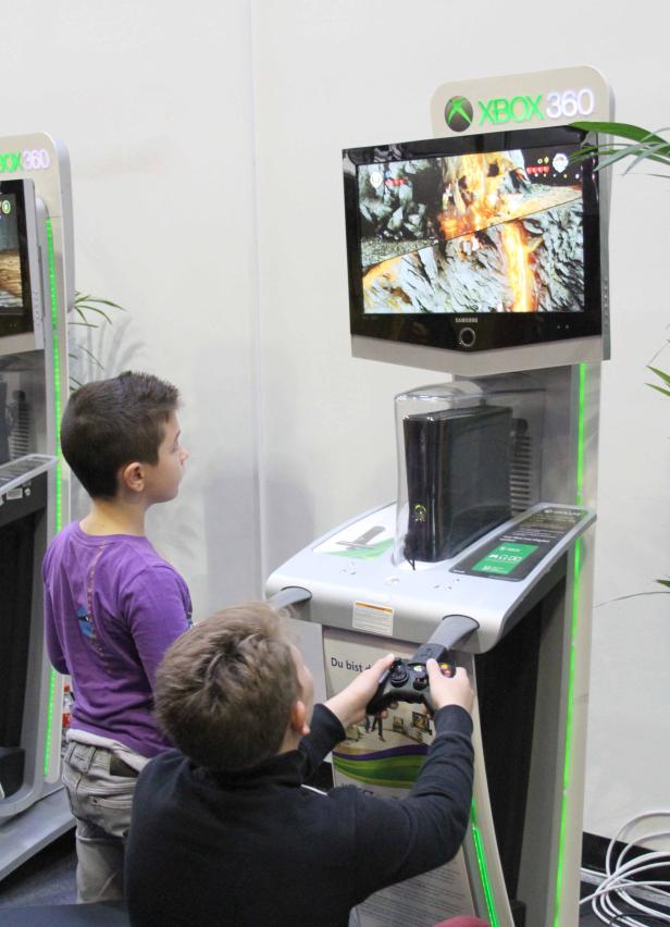 Zwei Jungen spielen an einer Xbox 360 Spielkonsole.
