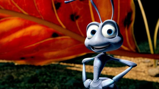 Die animierte Figur einer freundlich lächelnden blauen Ameise vor einem großen Blatt.