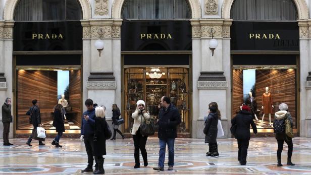 People stroll past Prada's fashion store in downto