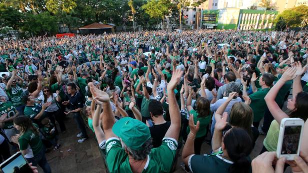 Fans of Chapecoense soccer team gather in the stre