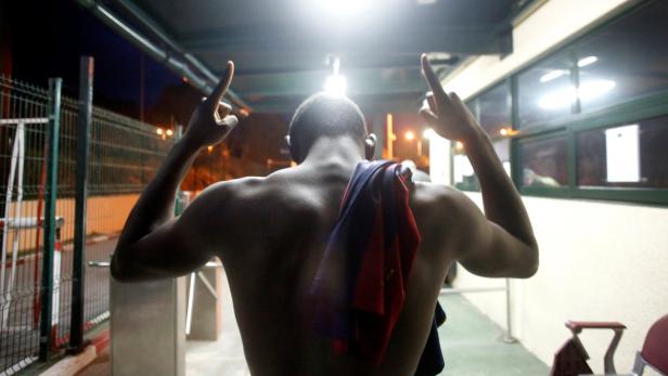 An African migrant reacts upon arriving at CETI, t