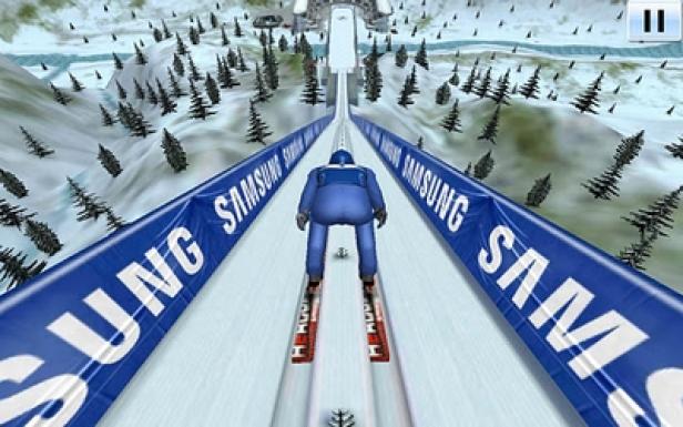 Greentube - Samsung - Ski Jump Giants - Game - Android-Edition Ein Skispringer fährt eine schneebedeckte Rampe hinunter, flankiert von Samsung-Bannern.