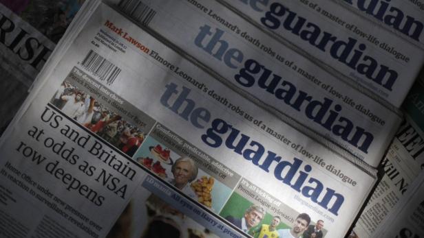 Copies of the Guardian newspaper are displayed at