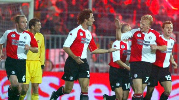 Mehrere Fußballspieler von Feyenoord Rotterdam laufen auf dem Spielfeld.