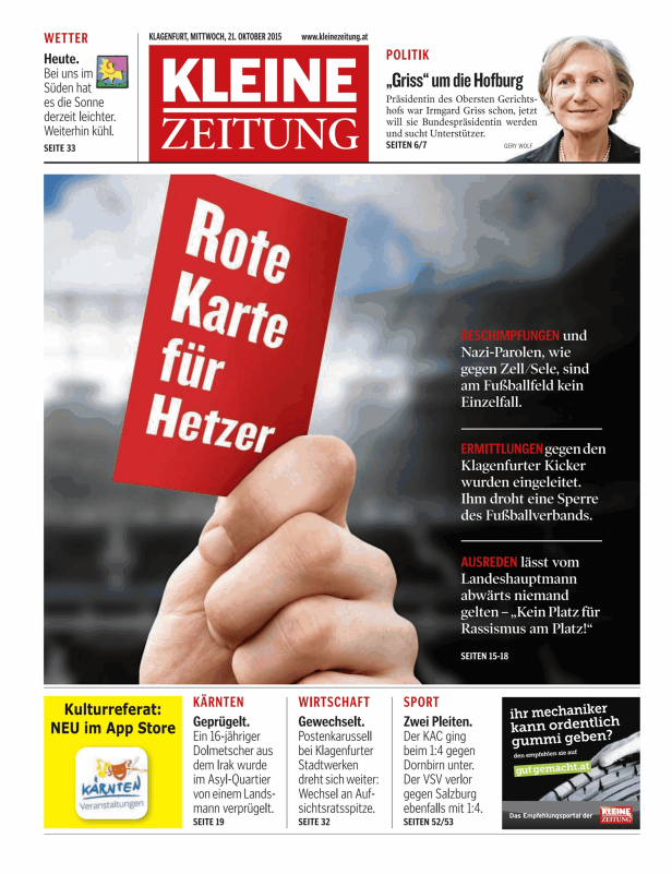 Eine Hand hält eine rote Karte mit der Aufschrift „Rote Karte für Hetzer“.