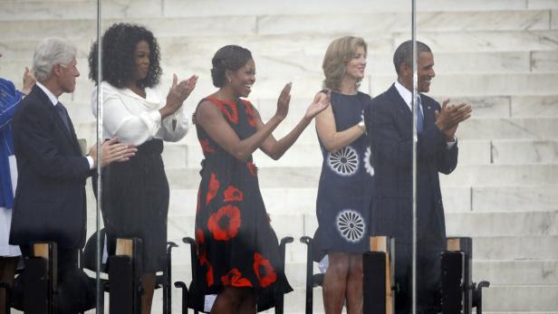 Bill Clinton, Oprah Winfrey, Michelle Obama und Barack Obama applaudieren bei einer Veranstaltung.