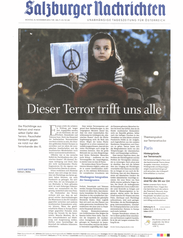 Ein Mädchen hält ein Schild mit einem Friedenssymbol und dem Eiffelturm hoch.