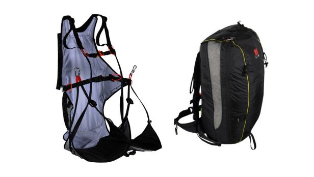 Ein Gleitschirmgurtzeug und ein Rucksack sind vor einem weißen Hintergrund zu sehen.
