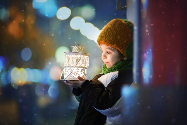 Cute boy, holding lantern outdoor