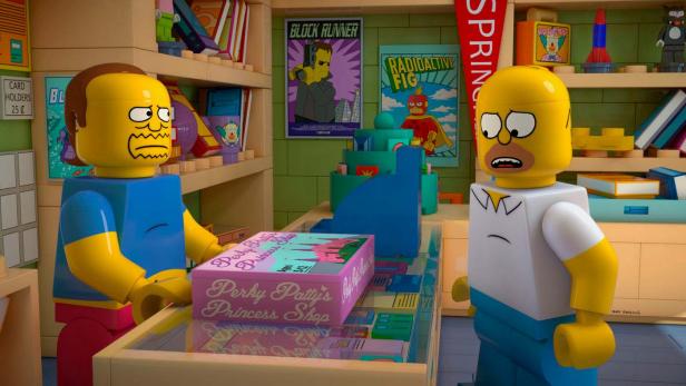 Lego-Figuren von Homer Simpson und einem Verkäufer in einem Spielzeugladen.
