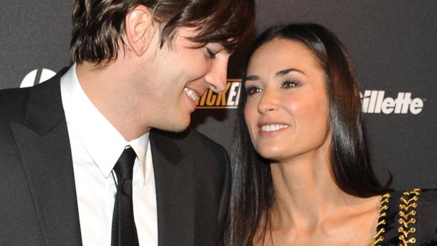 Ashton Kutcher und Demi Moore blicken sich auf einer Veranstaltung an.
