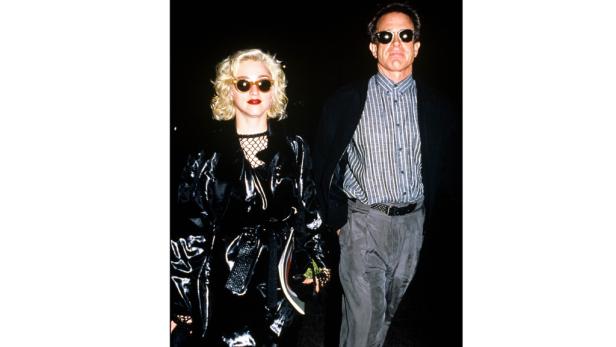 Madonna in einem glänzenden schwarzen Outfit mit einem Mann mit Sonnenbrille.