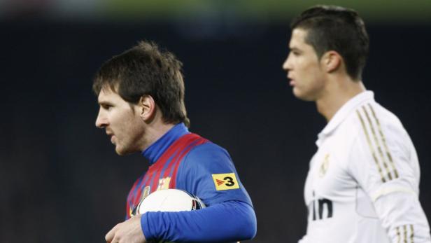 Lionel Messi mit Ball und Cristiano Ronaldo im Hintergrund.