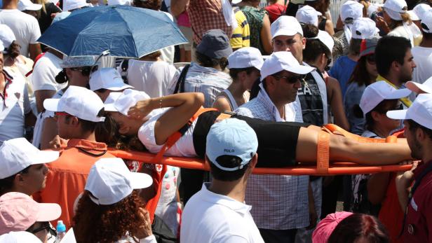 dapdA woman is carried by Lebanese Red Cross volunteers after she suffered a sunstroke during a mass held by Pope Benedict XVI, on the waterfront in Beirut, Lebanon, Sunday Sept. 16, 2012. Pope Benedict XVI celebrated an open-air mass for tens of thousand