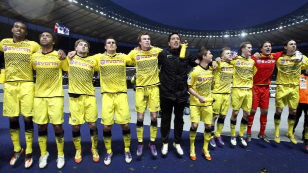 Die Mannschaft von Borussia Dortmund jubelt mit ihrem Trainer im Stadion.