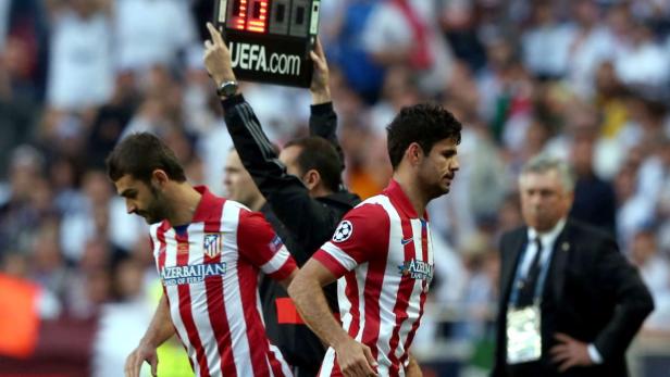 Zwei Fußballspieler von Atlético Madrid verlassen während eines Spiels das Feld.