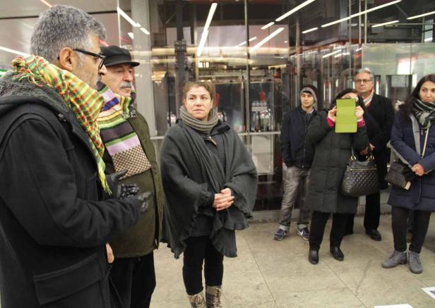 Eine Gruppe von Menschen steht vor einem Gebäude.